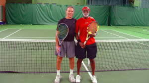Two male friend playing tenins together in one of our tennis leagues. located inside at Vermont Sport and Fitness club
